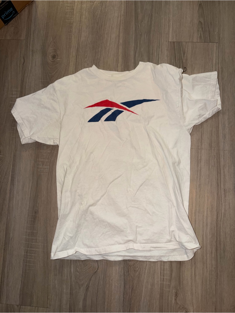 White rebook tshirt with Red & Blue Graphic